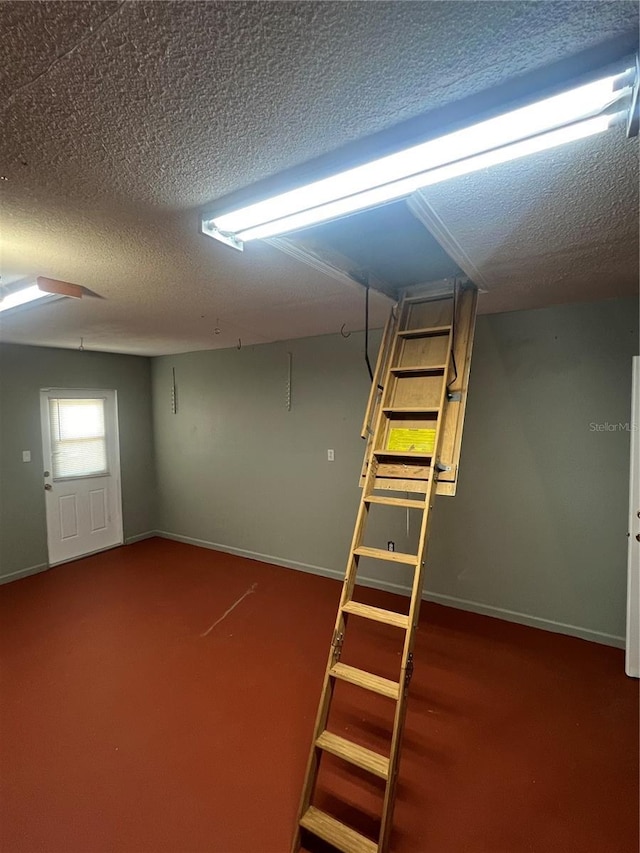 basement with carpet and a textured ceiling