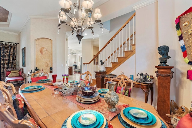 dining area featuring crown molding and a notable chandelier