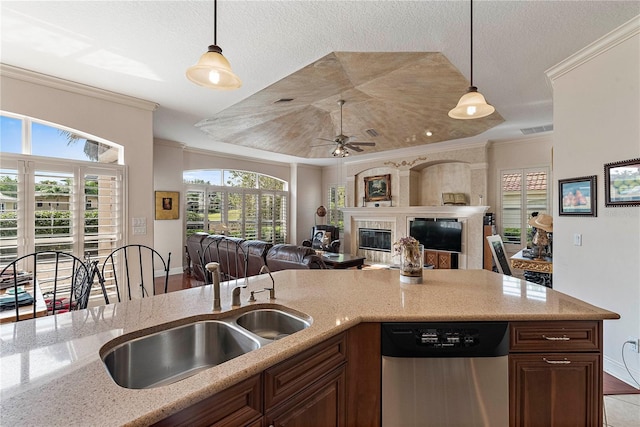 kitchen featuring crown molding, stainless steel dishwasher, light stone counters, and hanging light fixtures