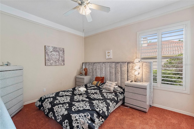 carpeted bedroom featuring multiple windows and ceiling fan