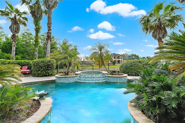 view of swimming pool featuring an in ground hot tub