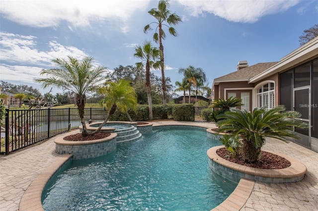 view of pool featuring a water view and an in ground hot tub