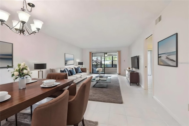 living room with light tile patterned floors and a notable chandelier