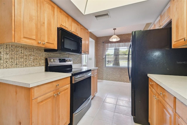 kitchen featuring hanging light fixtures, light tile patterned flooring, light brown cabinets, and black appliances