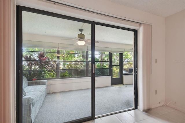 doorway with ceiling fan