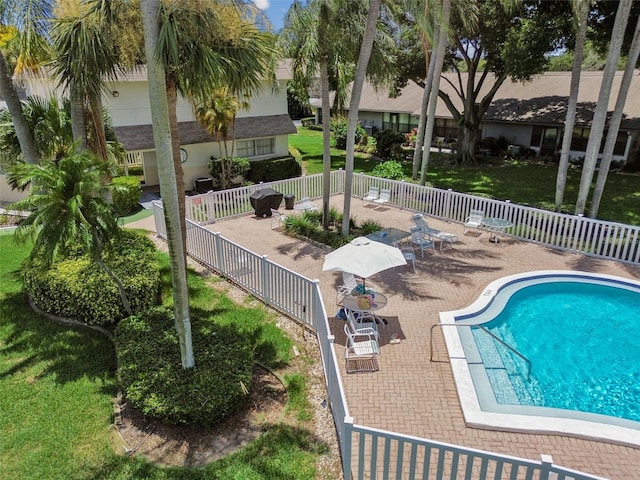 view of pool featuring a lawn and a patio