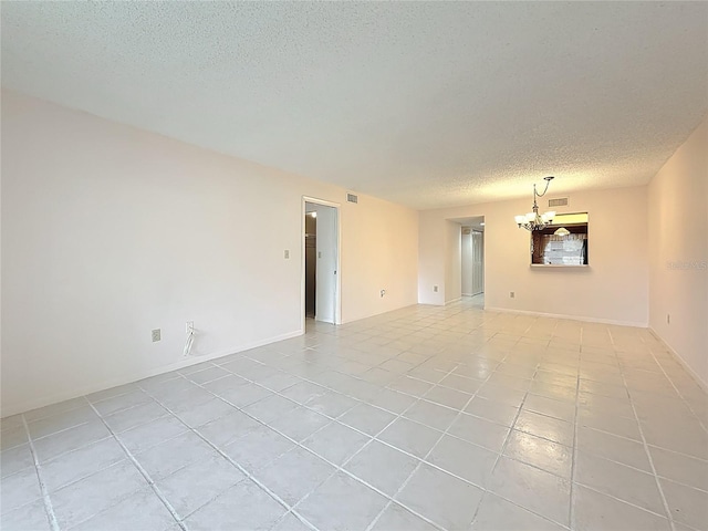 1601 43rd St N Unit 133, Saint Petersburg, FL 33713 - unfurnished room with light tile patterned floors, visible vents, a textured ceiling, and an inviting chandelier