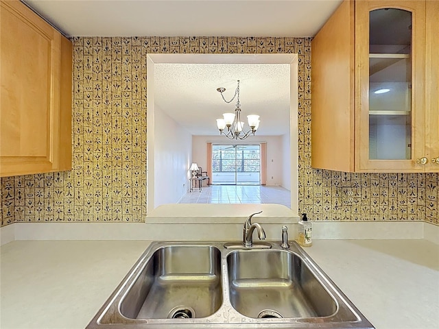 1601 43rd St N Unit 133, Saint Petersburg, FL 33713 - kitchen with a chandelier, decorative backsplash, light countertops, and a sink