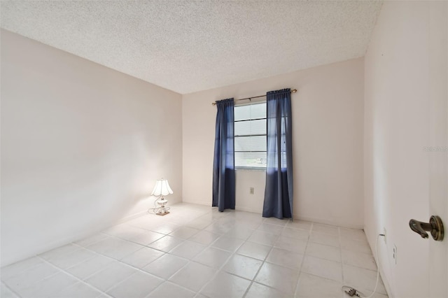 1601 43rd St N Unit 133, Saint Petersburg, FL 33713 - empty room with a textured ceiling and light tile patterned flooring