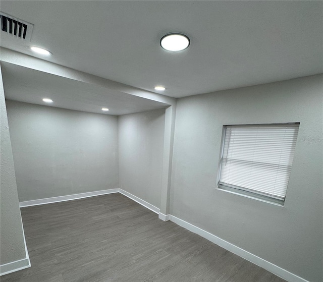 basement featuring dark hardwood / wood-style flooring