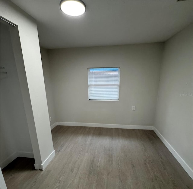 empty room with light hardwood / wood-style flooring