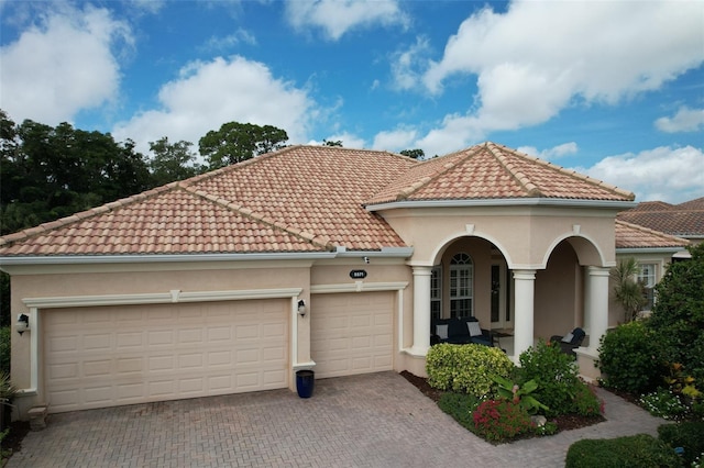 mediterranean / spanish house featuring a garage