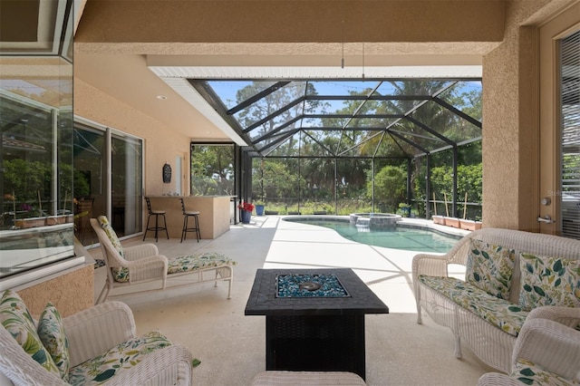 view of patio with a bar, an in ground hot tub, and a lanai