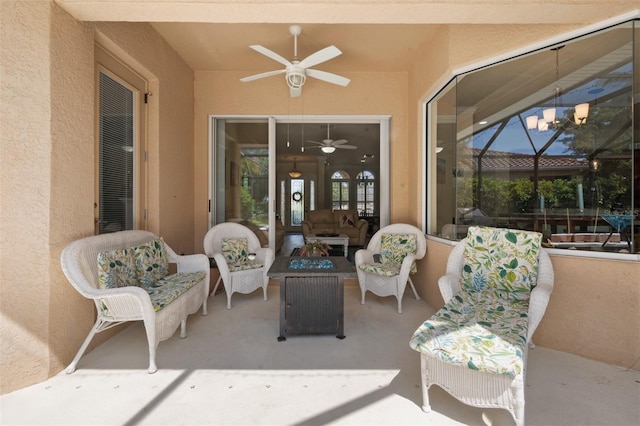 view of patio / terrace featuring ceiling fan, an outdoor living space, and a lanai