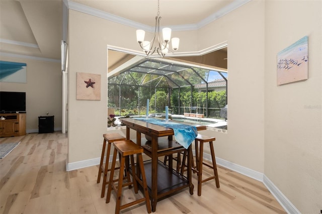 dining space with ornamental molding and light hardwood / wood-style flooring