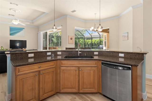 kitchen with dishwasher, sink, dark stone counters, hanging light fixtures, and light hardwood / wood-style flooring