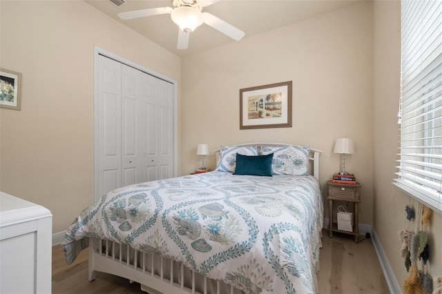 bedroom with hardwood / wood-style floors, a closet, and ceiling fan