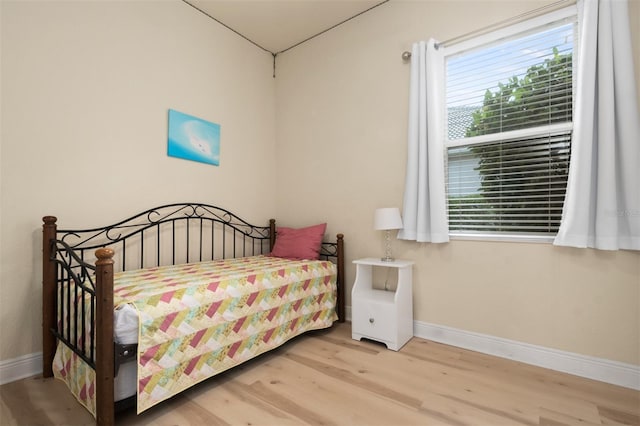 bedroom with hardwood / wood-style floors