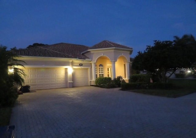 mediterranean / spanish-style house featuring a garage