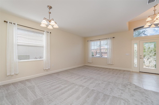 carpeted foyer featuring a notable chandelier