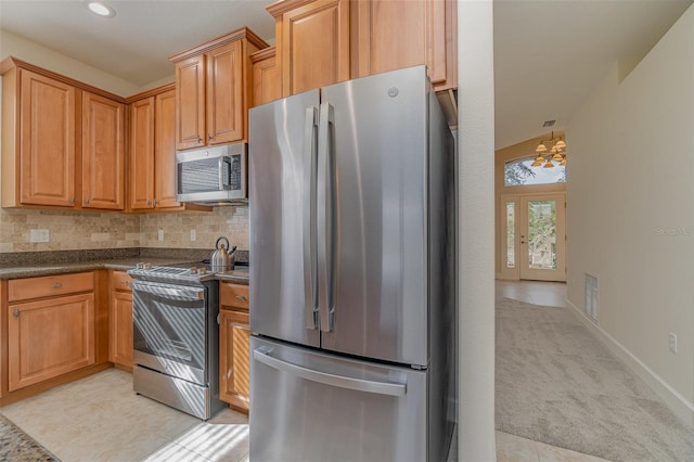 kitchen with stainless steel appliances, tasteful backsplash, and light tile patterned flooring