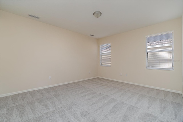 unfurnished room featuring light colored carpet