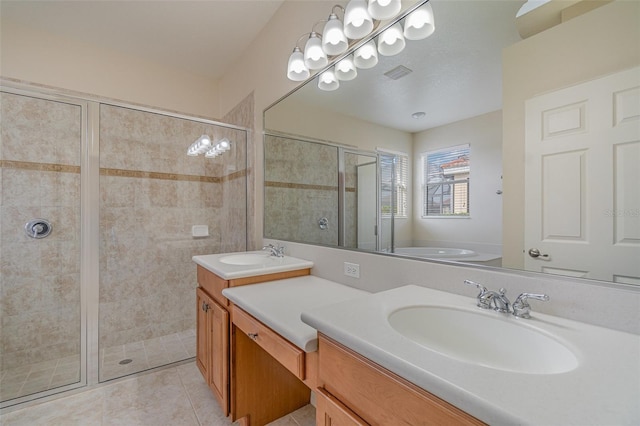 bathroom with tile patterned floors, vanity, and a shower with shower door