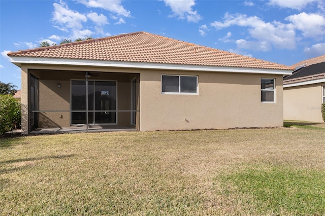 rear view of house featuring a yard