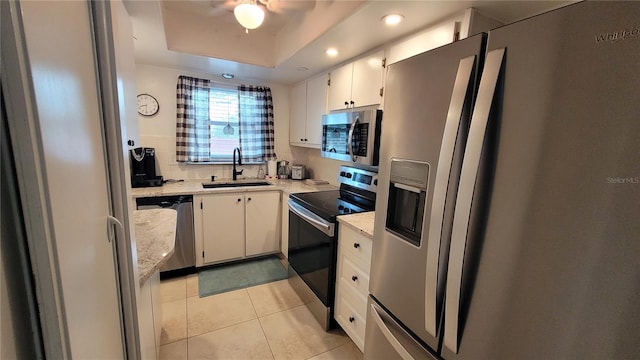 5880 38th Ave N Unit 204, Saint Petersburg, FL 33710 - kitchen with white cabinetry, stainless steel appliances, a raised ceiling, and sink