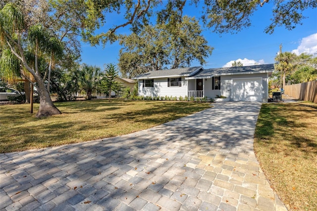 ranch-style house with a garage and a front lawn