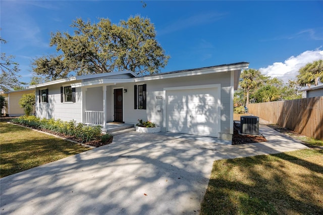 ranch-style home featuring central AC, a garage, and a front yard