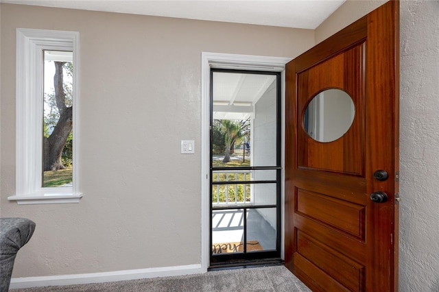 view of carpeted foyer entrance