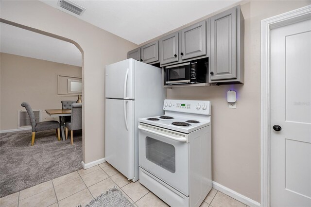 kitchen featuring electric stove, light tile patterned flooring, and gray cabinetry