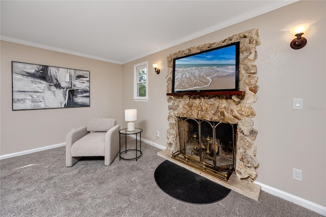 sitting room with a stone fireplace, carpet floors, and ornamental molding