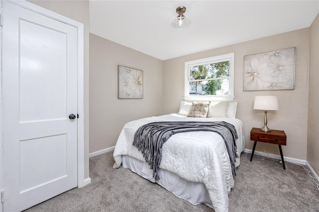 bedroom featuring light carpet