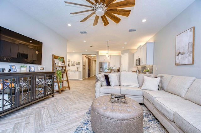 living room featuring ceiling fan and light parquet floors