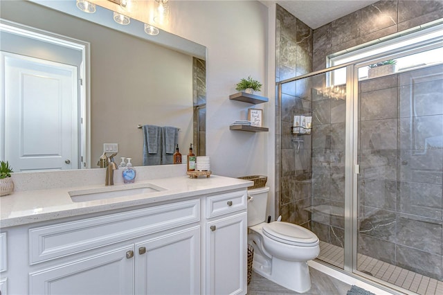 bathroom with vanity, toilet, and walk in shower