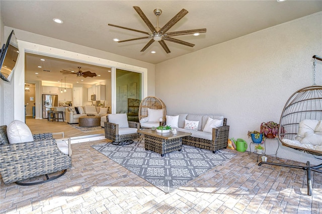 view of patio featuring an outdoor living space and ceiling fan