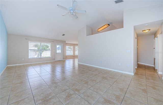 tiled empty room with high vaulted ceiling and ceiling fan