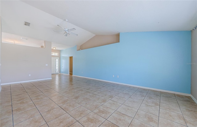 empty room with vaulted ceiling, light tile patterned flooring, and ceiling fan