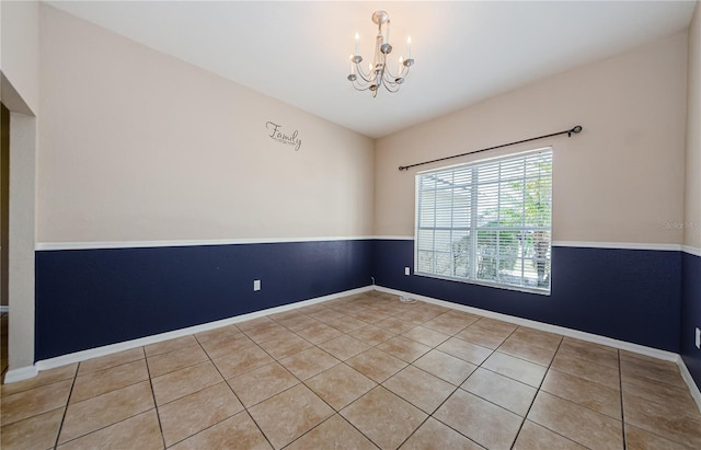 empty room featuring light tile patterned floors and an inviting chandelier