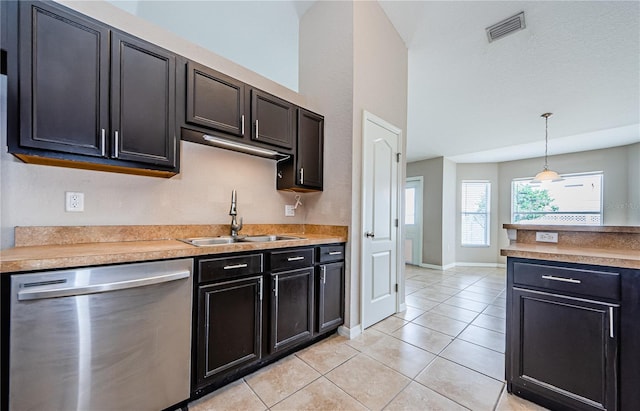 kitchen featuring dishwasher, sink, light tile patterned floors, and decorative light fixtures