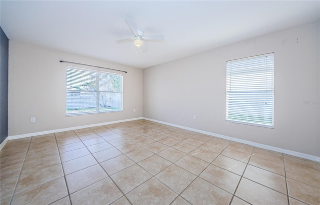 tiled spare room with ceiling fan