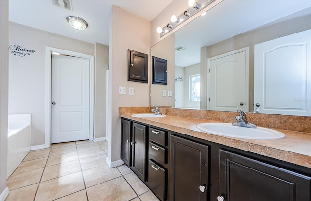 bathroom with vanity, a bathing tub, and tile patterned floors