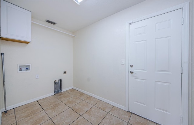 clothes washing area featuring cabinets, hookup for a washing machine, light tile patterned floors, and hookup for an electric dryer