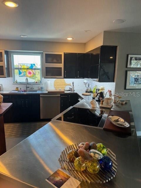 kitchen with tasteful backsplash, sink, and stainless steel dishwasher