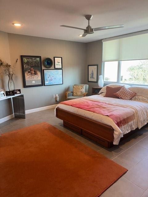 tiled bedroom with ceiling fan