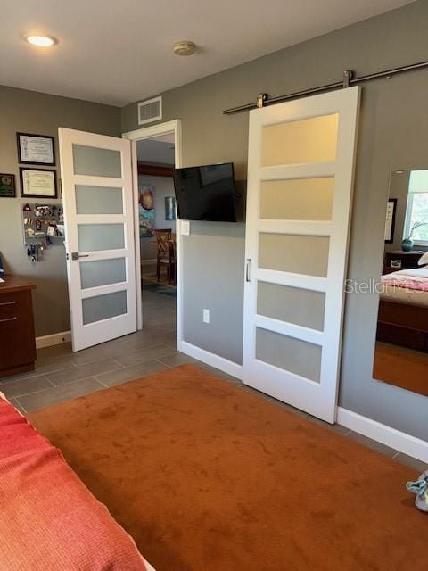 tiled bedroom with a barn door