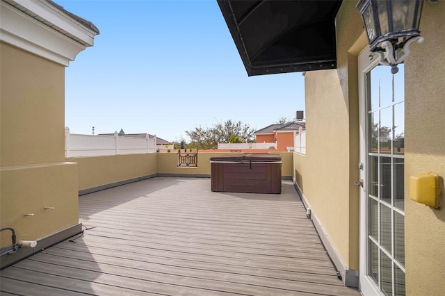 wooden terrace featuring a hot tub