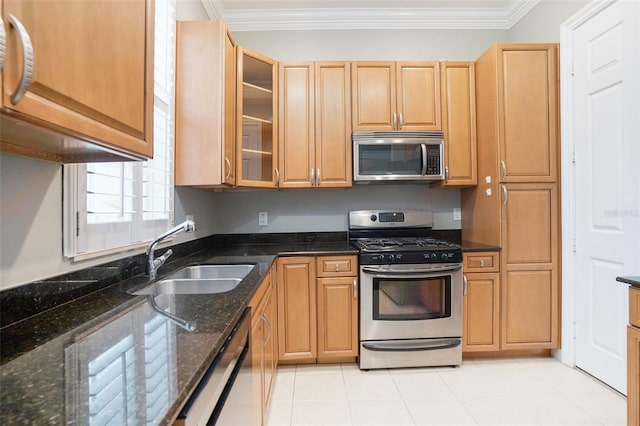 kitchen featuring ornamental molding, glass insert cabinets, appliances with stainless steel finishes, and a sink